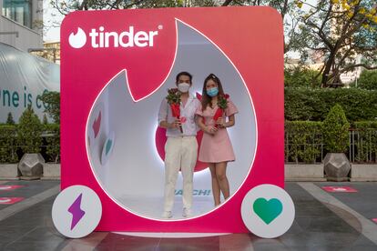 A couple at a Tinder advertising booth in Bangkok, Thailand, on February 14, 2022.