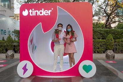 A couple at a Tinder advertising booth in Bangkok, Thailand, on February 14, 2022.