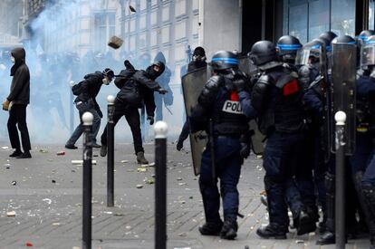Un grupo de manifestantes lanza piedras contra la policía en París.