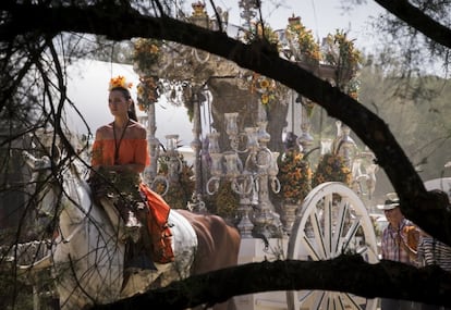 Una romera a caballo de la Hermandad de Puebla del Rio (Sevilla) acompaña al Simpecado durante el camino hacía la aldea almonteña de El Rocío (Huelva).