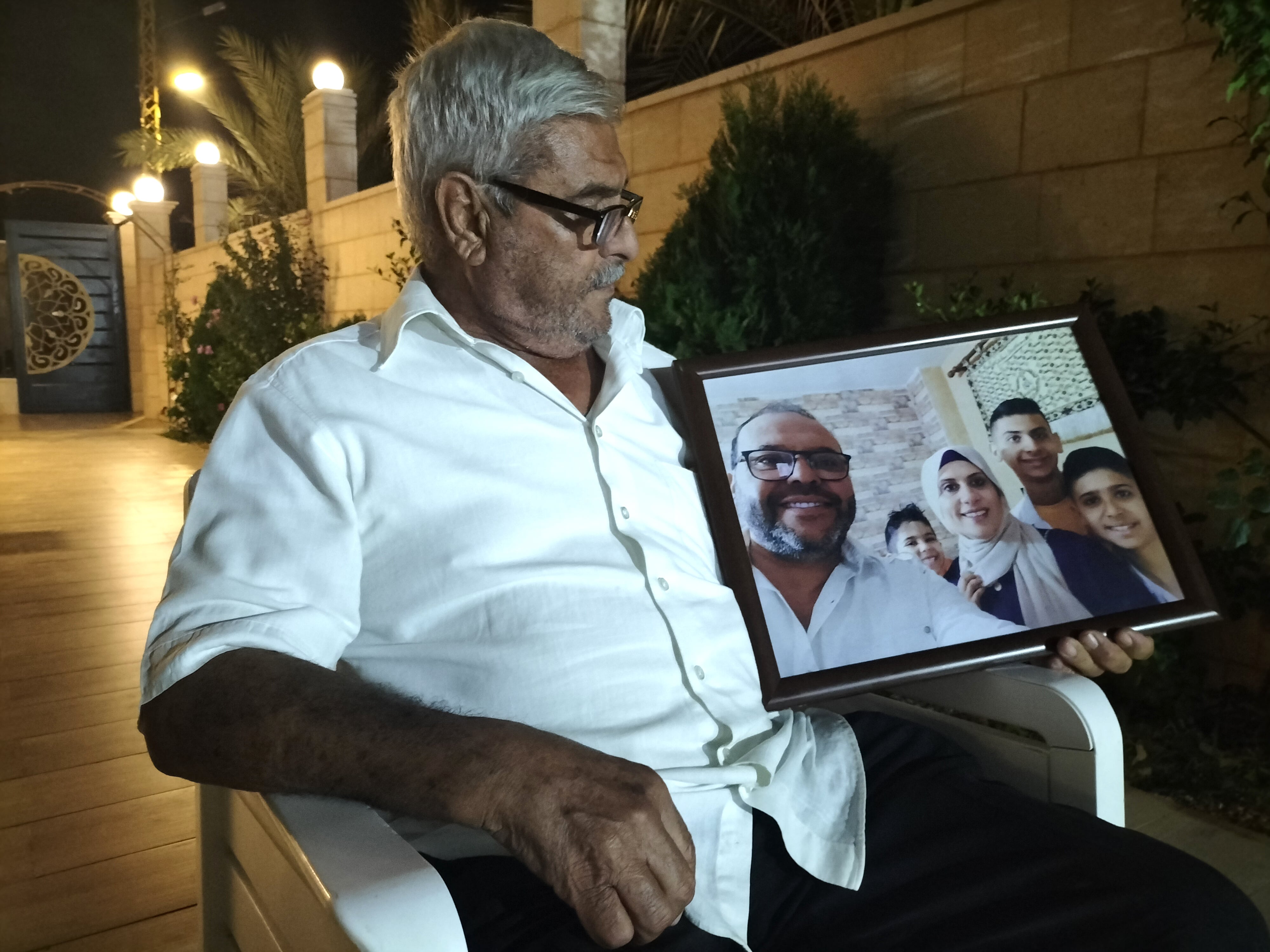 Mahmud Skafi, con una foto de su familia. A la izquierda, en primer plano, su hijo Ali, muerto en el bombardeo en Ain El Delb, el pasado jueves en el pueblo de Yims Naya.