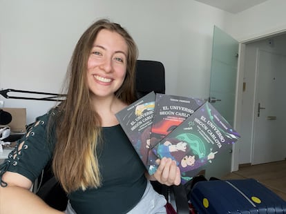 Teresa Paneque holds three volumes of 'The Universe According to Carlota', a series of popular science children's books.