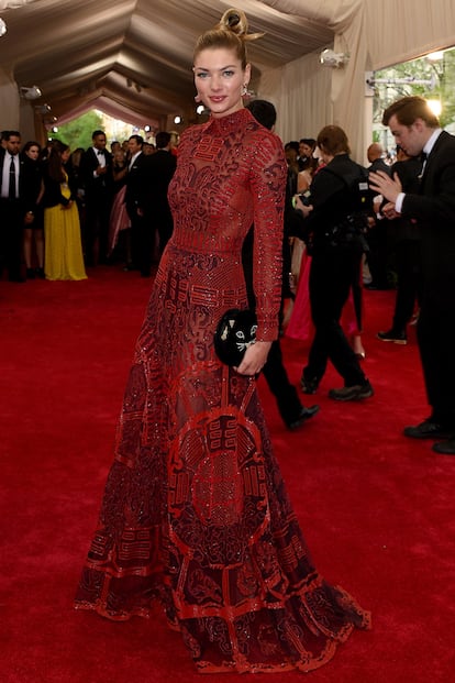 Jessica Hart con vestido rojo y clutch gatuno de Charlotte Olympia.