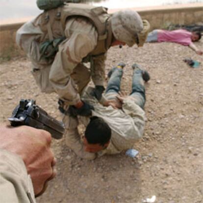 Dos soldados de EE UU detienen a un saqueador ayer en Bagdad.