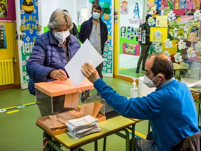 Um homem carrega material eleitoral em um colégio de Las Rozas (Madri), na segunda-feira.