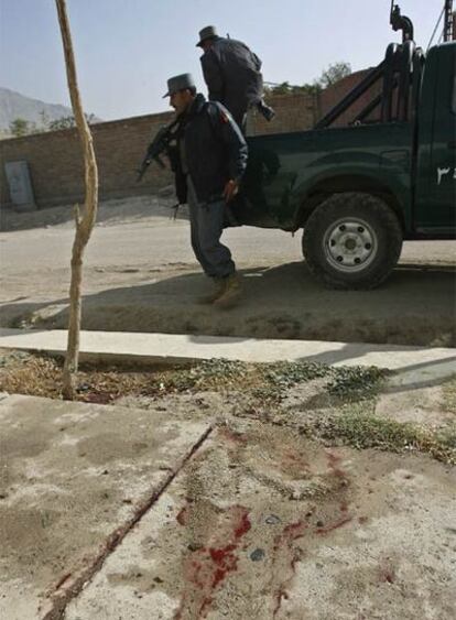 Policías afganos inspeccionan el lugar donde la cooperante ha sido asesinada por talibanes.