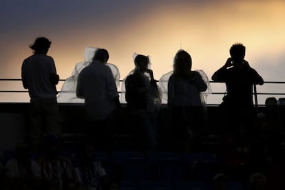 La lluvia obligó a los espectadores a utilizar chubasqueros durante la final disputada entre Roger Federer y Novak Djokovic en el Open de Estados Unidos celebrado en Nueva York el pasado septiembre.