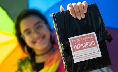 Mulher exibe livro distribuído de graça em ação de Felipe Neto na Bienal do Rio.