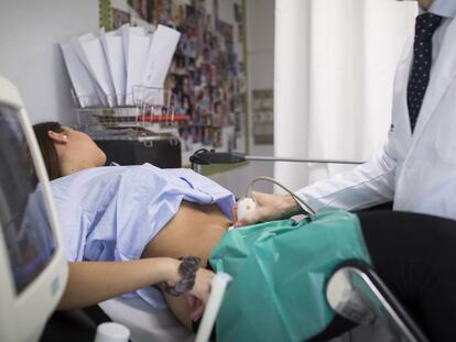 Un doctor hace una ecografía a una embarazada.