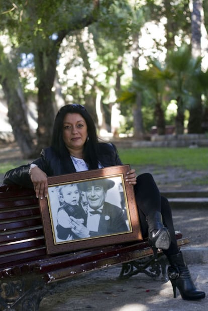 Inés Sánchez, daughter of Bernardo Sánchez Bascuñada, poses with a photograph of her executioner father.