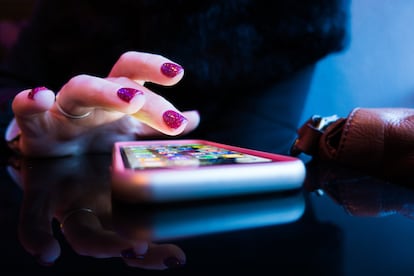 A woman uses her iPhone device.