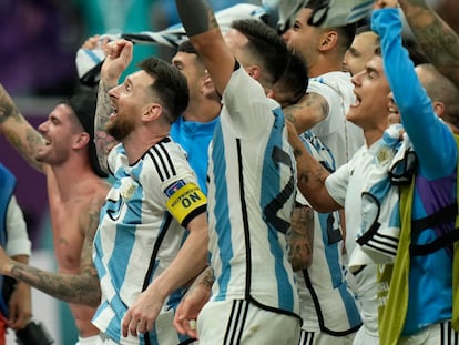 Argentina's Lionel Messi, left, celebrates with teammates after defeating the Netherlands off penalties during the World Cup quarterfinal soccer match between the Netherlands and Argentina, at the Lusail Stadium in Lusail, Qatar, Saturday, Dec. 10, 2022. (AP Photo/Francisco Seco)