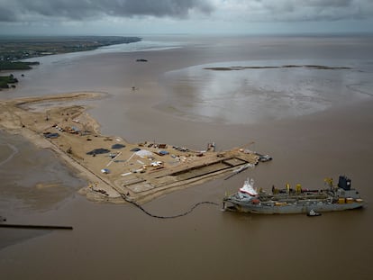 A ship creates an artificial island by extracting offshore sand to create a coastal port for offshore oil production at the mouth of the Demerara River in Georgetown, Guyana, Wednesday, April 12, 2023