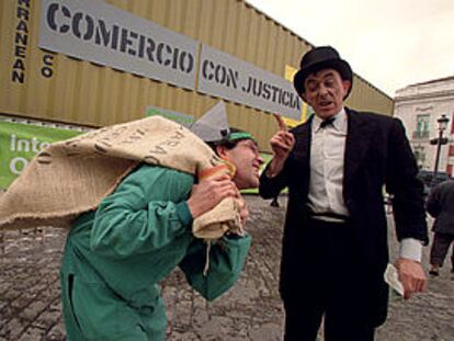 Dos actores escenifican <b></b><i>Las reglas del comercio mundial</i> en la Puerta del Sol de Madrid.