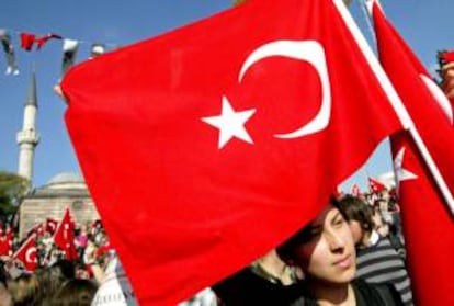 Una persona sostiene una bandera nacional durante una protesta frente a una mezquita en Estambul, Turquía. EFE/Archivo