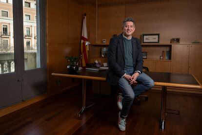 Quirós poses in his office. 