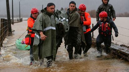 Carabineros y personal de emergencias evacuan a personas tras el desborde del río Pichilo, en la comuna de Arauco, región del Bio Bío (Chile), el 11 de junio.