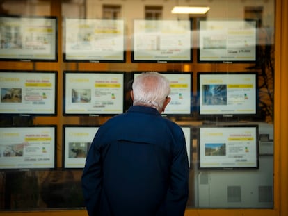 Un hombre mira anuncios de vivienda en una agencia inmobiliaria en Madrid.