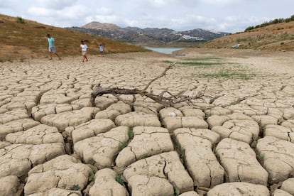 Varias personas caminan por el pantano de La Viñuela (Málaga), que se encuentra al 12% de su capacidad.