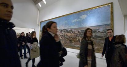 Visitantes pasan por delante de &#039;La batalla de Tetu&aacute;n&#039; de Fortuny, en el MNAC.