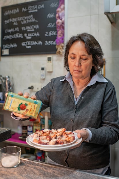 Ana Marcén regenta junto a su marido Alberto Escribano la marisquería Los Crustáceos. En esta imagen, espolvorea pimentón de la Vera sobre una ración de pulpo a la gallega. 