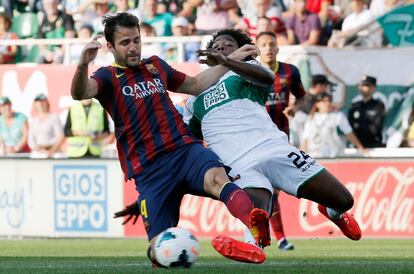 Cesc Fábregas lucha un balón con Carlos Sánchez