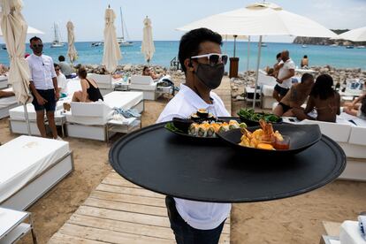 A worker at the Blue Marlin carrying a tray of food last Thursday.
