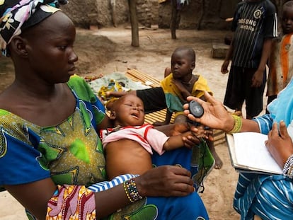 Una voluntaria mide la respiración de un niño en Malí.