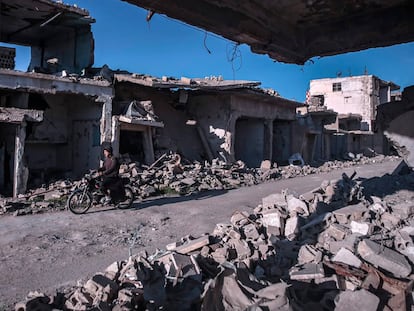 A man rides a motorbike in Duma, on the outskirts of Damascus.