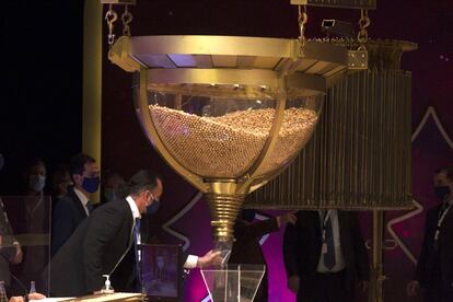 Personnel checking one of the drums containing the balls with the lottery numbers ahead of the draw on Tuesday.