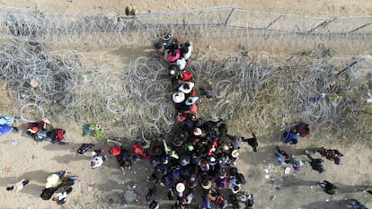 Hundreds of migrants wait for Texas National Guard agents to allow them to enter the border wall in Ciudad Juarez, Mexico, on March 20, 2024.