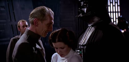 El Gran Moff Tarkin (Peter Cushing), la princesa Leia (Carrie Fisher) y Darth Vader (David Prowse) en un fotograma de 'La Guerra de las Galaxias' (1977). Los tres personajes volvieron a coincidir en 'Rogue One' (2016), los dos primeros recreados digitalmente y el tercero interpretado por otro actor (Spencer Wilding).