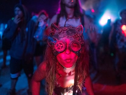 Woman in a rave party wearing special glasses