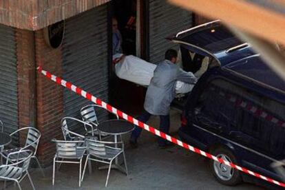 Empleados de los servicios funerarios introducen en un furgón el cuerpo del concejal socialista de Orio Juan Priede, último político asesinado por ETA.