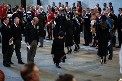 El príncipe Enrique y su mujer, Meghan Markle, hacen una reverencia al féretro de la reina Isabel II en Westminster Hall, este miércoles.