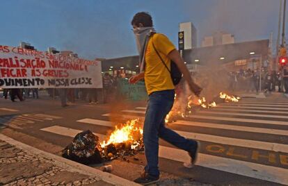 A protestor in front of barricades at a demonstration.