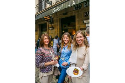 Three women show off a pintxo outside Gandarias bar.