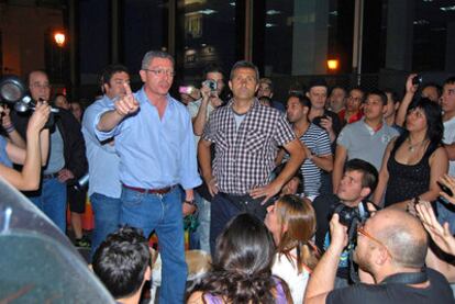 Madrid Mayor Alberto Ruiz-Gallardón (pointing) addresses protestors outside his home on Monday night.