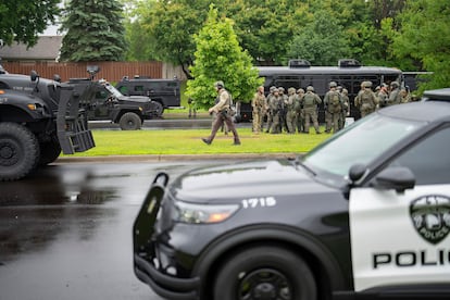 Law enforcement officers including local police, sheriffs and the FBI, stage less than a mile from a shooting in Brooklyn Park, Minn. on Saturday, June 14, 2025. 