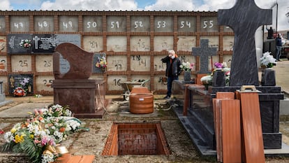 A man attends his mother’s burial, during the coronavirus outbreak in Spain.