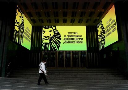 Una mujer camina por delante del Teatro Lope de Vega, cerrado durante el estado de emergencia, en la Gran Vía de Madrid.