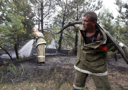 Dos bomberos combate un incendio declarado en la localidad de Voronezh