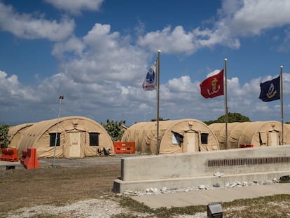 In this April 18, 2019, file photo, in this photo reviewed by U.S. military officials, flags fly in front of the tents of Camp Justice in Guantanamo Bay Naval Base, Cuba.