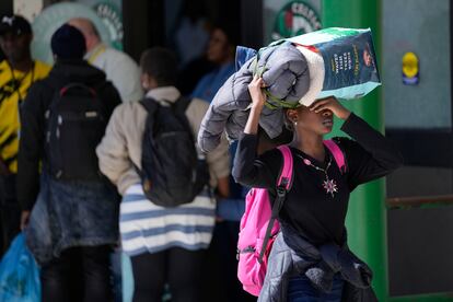 Asylum seekers arrive with their belongings at the Portland Expo Center, Monday, April 10, 2023