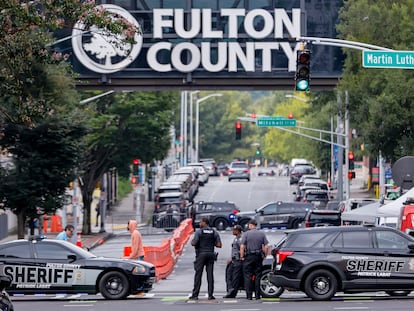 Fulton County Sheriff's Office deputies block a road as enhanced security measures are implemented outside the Fulton County Courthouse ahead of a possible grand jury indictment against Donald Trump.
