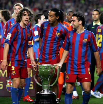 Ronaldinho, Carles Puyol y Xavi Hernández posan con el trofeo de campeones de la Liga de Fútbol 2005- 2006. El Barça se proclamó campeón a tres jornadas del final de la temporada.