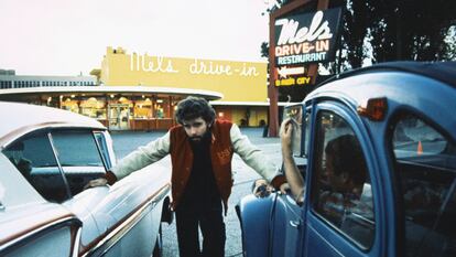 George Lucas posa entre dos coches durante el rodaje de 'American Graffiti', en San Francisco en 1973.