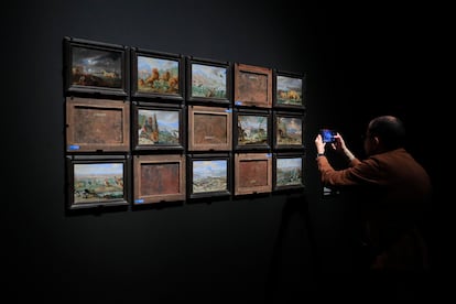 Un hombre fotografía algunas de las obras expuestas, por delante y por detrás, en la nueva exposición del Museo del Prado.