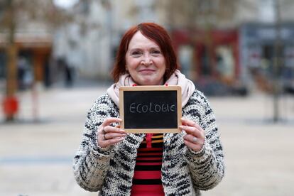 Marie-Laure Mathonnat, 54, a public sector worker, holds a blackboard with the word "ecologie" (ecology), the most important election issue for her, as she poses for Reuters in Chartres, France February 1, 2017. She said: "I have always voted, but this time, really, I don't think I'll go. I'm fed up with politics. I don't believe in it anymore." REUTERS/Stephane Mahe SEARCH "ELECTION CHARTRES" FOR THIS STORY. SEARCH "THE WIDER IMAGE" FOR ALL STORIES