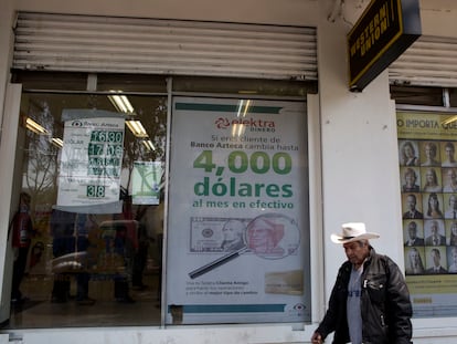 Un hombre camina junto a un negocio de envío y recepción de dinero, en Ciudad de México, en una imagen de archivo.